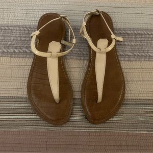 Size 6 Women’s T-Strap Sandal in brown leather like material.